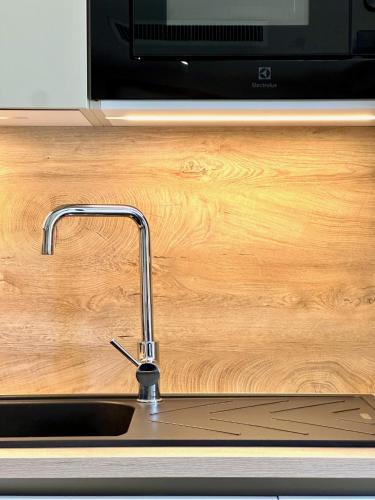 un comptoir de cuisine avec un évier et un micro-ondes dans l'établissement Entre mer et golf à Beauvallon face à Saint-Tropez, à Grimaud