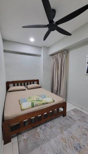 a bedroom with a bed with a ceiling fan at Have a good Rest in Kajang