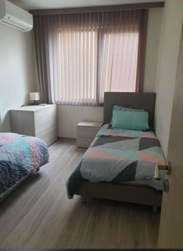 a bedroom with a bed and a window at Siber retreat in Stara Zagora