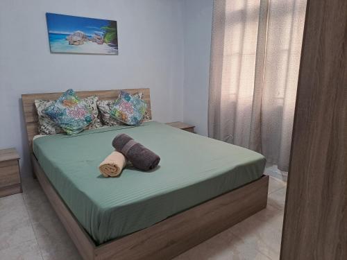 a bedroom with a bed with a towel on it at West Beach in Flic-en-Flac