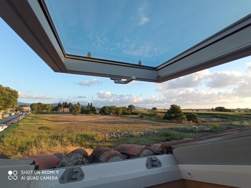 a window in a house with a view of a field at Casa Rubini in Paestum