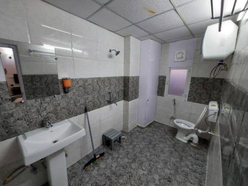 a bathroom with a sink and a toilet at Skyline 2BHK Independent flat in Lucknow