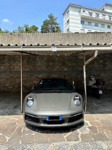 a silver car parked under a garage with a roof at Un Passo dal Mare in Zoagli