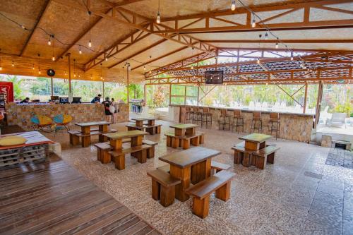 a room with wooden tables and benches in it at Arenal Secret Gardens in Fortuna
