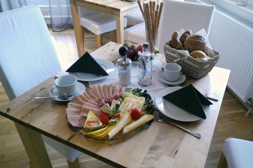 a wooden table with a plate of food on it at Landhaus Semmering in Semmering
