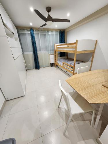 Cette chambre dispose d'une table à manger et de lits superposés. dans l'établissement Studio Marina baie des Anges, 3 lits,clim, plages, à Villeneuve-Loubet