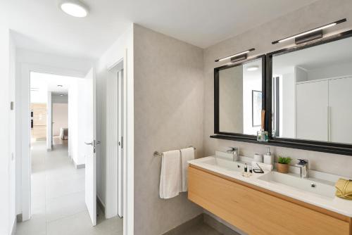 a bathroom with a sink and a mirror at Las Yucas 12 by VillaGranCanaria in Salobre