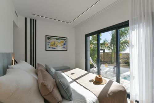 a bedroom with a bed and a large window at Las Yucas 12 by VillaGranCanaria in Salobre