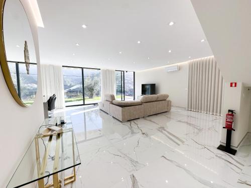 a living room with a couch and a mirror at Villa Montana in São Vicente