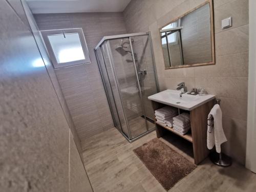 a bathroom with a shower and a sink at Villa Isabela Ičići in Ičići