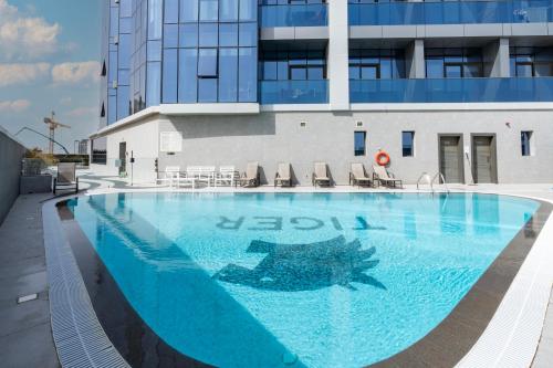 a large swimming pool in front of a building at Appartement Dubai in Dubai