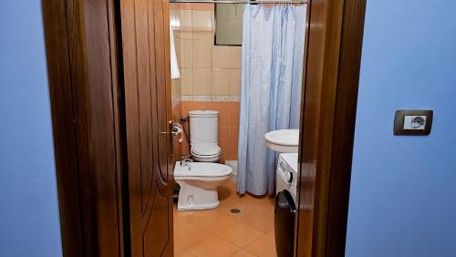 a bathroom with a toilet and a sink at Guest House Edison in Berat