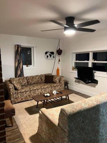 a living room with a couch and a ceiling fan at Sunset View in OʼLeary