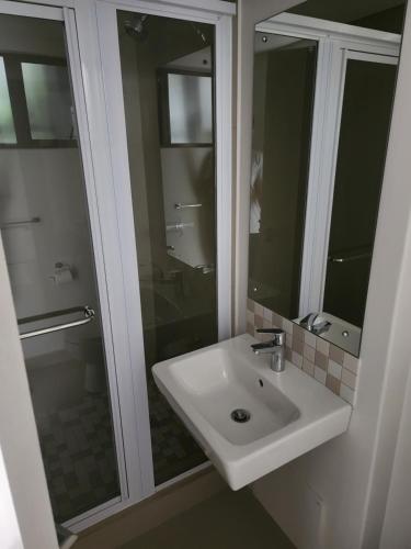a bathroom with a sink and a glass shower at Mkhonto-PR The Millenial Durban, Umhlanga in Durban