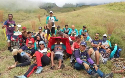 a group of people posing for a picture on a hill at Joben Evergreen Camp Centre in Tetebatu