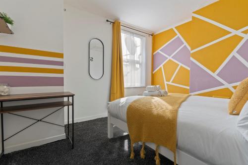 a hotel room with a bed and a window at STAYZED N2 - Modern, Colourful NG7 Home, Next To City Centre, Lots Of Amenities, Ideal for Long & Short Stays. in Nottingham