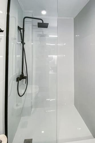 a shower with a glass door in a bathroom at Syntagma square, 60sqm Platinum suite in Athens