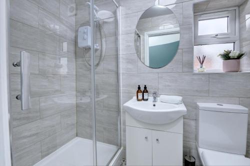 a bathroom with a shower and a toilet and a sink at Merrivale House in Birmingham