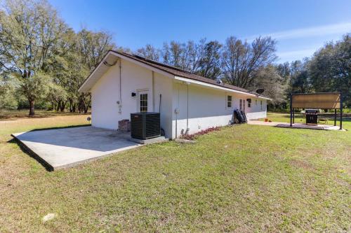 a building with a basketball hoop in a field at Gas Grill and Fire Pit Peaceful Dunnellon Home! in Dunnellon