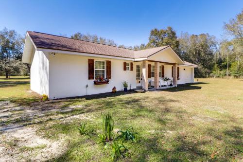 a small white house with a large yard at Gas Grill and Fire Pit Peaceful Dunnellon Home! in Dunnellon