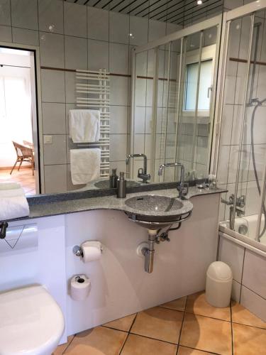 a bathroom with a sink and a mirror at Casa Concerto in Brissago