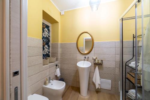 a bathroom with a sink and a mirror at Dimora Don Antonio in Pontecagnano