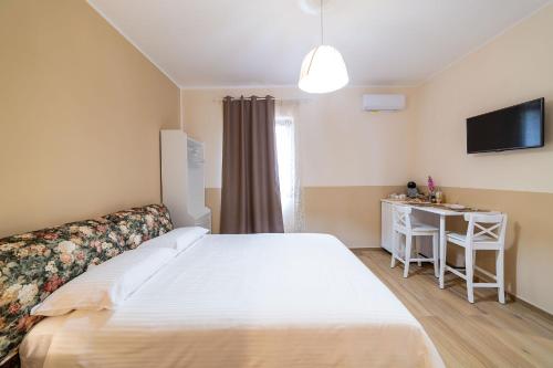 a bedroom with a large bed and a desk at Dimora Don Antonio in Pontecagnano
