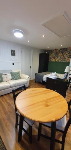 a living room with a table and a bed at Self-contained Guest Suite in Guildford
