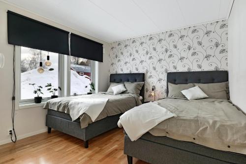 1 Schlafzimmer mit 2 Betten und einem Fenster in der Unterkunft Guestly Homes - Homely 2BR Apartment with 3 Beds in Boden