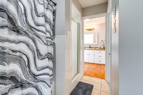 a bathroom with a shower with a black and white shower curtain at Expansive Bertram Retreat with Pool, on 28 Acres! in Bertram