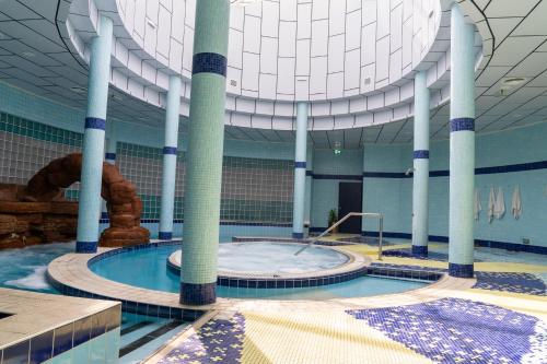 a large swimming pool with a large ceiling at eStay Hotel in Dubai