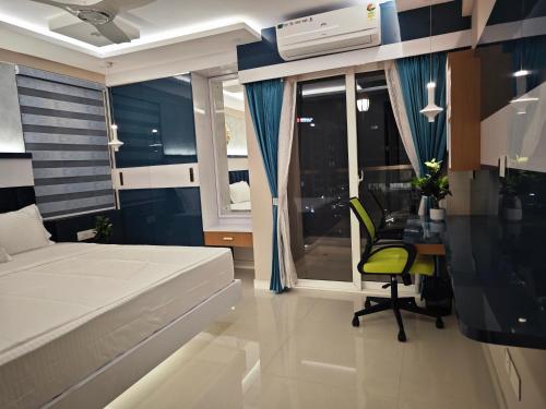 a bedroom with a bed and a desk and a chair at Evara - Premium Fully AC - 3BHK Luxury Apartment with Style in Trivandrum