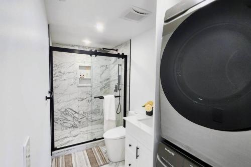 a bathroom with a shower and a toilet and a sink at Serene High-celling Retreat in Oakville