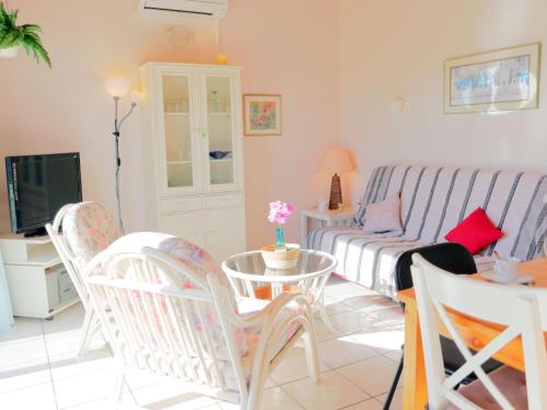 un salon avec un canapé, une table et des chaises dans l'établissement Apartment Port La Roquille-2 by Interhome, au Cap d'Agde