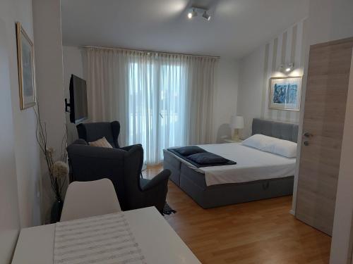 a bedroom with a bed and a couch in a room at Apartments Fantasia in Pula