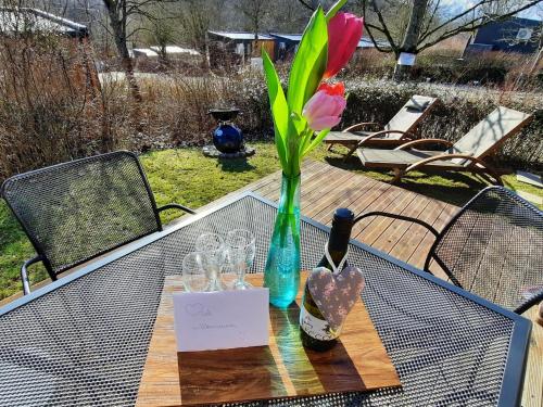 a table with a vase with a flower and glasses at Holiday Home Seeperle by Interhome in Wemding