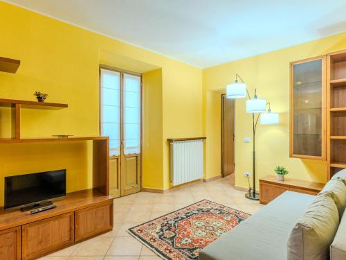 a living room with a tv and a couch at Apartment Claudio by Interhome in Luino