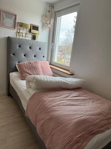 a bedroom with a bed with a window at The Cheerful Villa In Perstorp in Perstorp