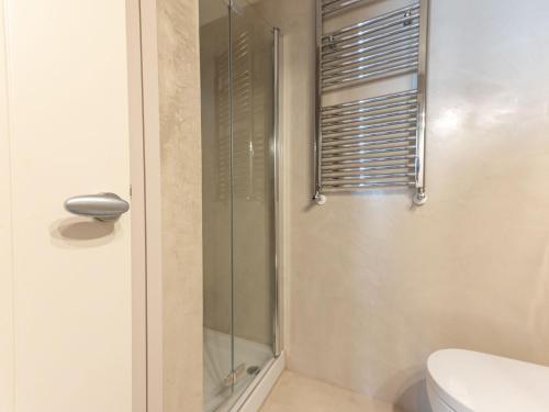 a shower with a glass door in a bathroom at Apartment A 33 by Interhome in Punta Ala