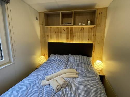 a bedroom with a bed with two towels on it at Holiday Home Carola by Interhome in Wemding