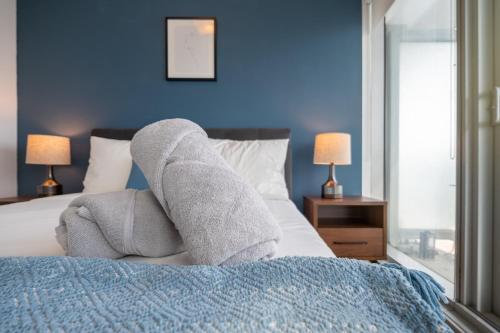 a pair of socks on a bed in a bedroom at Downtown Apartments (5) in Toronto