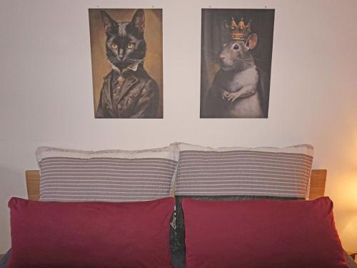 two pictures of a cat and a dog on a wall at Apartment Sandra Falch by Interhome in Flirsch
