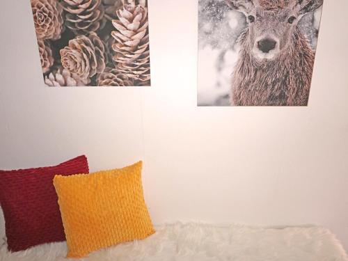 a bedroom with two pictures of a deer on the wall at Apartment Sandra Falch by Interhome in Flirsch