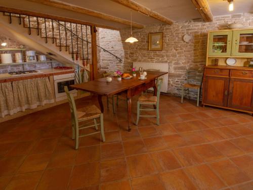 a kitchen with a wooden table and chairs at Villa Mega by Interhome in Barban