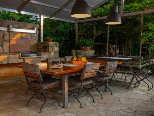 a patio with a table and chairs and a grill at Villa Mega by Interhome in Barban