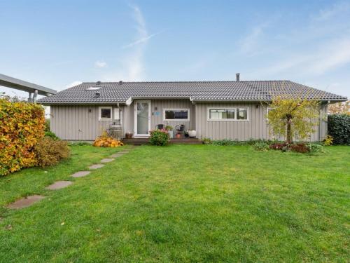 a house with a green yard in front of it at Holiday Home Elja - 400m to the inlet in Sealand by Interhome in Jægerspris