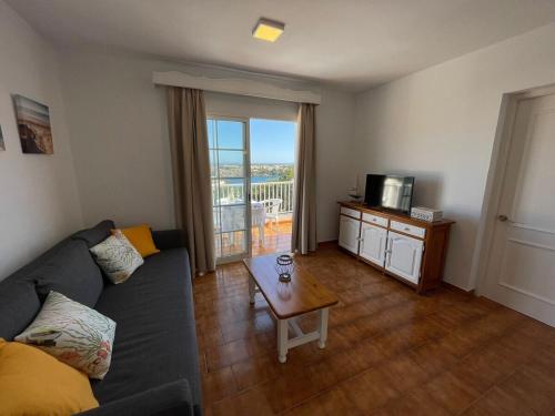 a living room with a couch and a coffee table at Apartamento 204 Castell Sol CB in Arenal d'en Castell