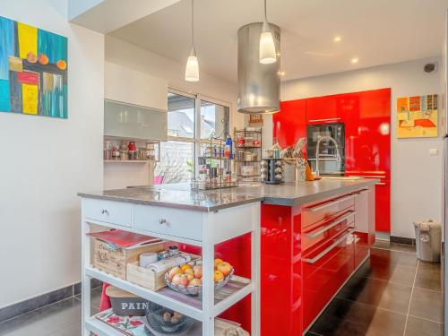 a kitchen with red cabinets and a counter top at Holiday Home Villa Rucette by Interhome in La Richardais