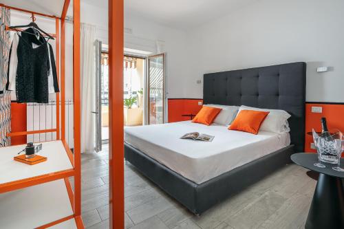 a bedroom with a large bed with orange pillows at Conny's House in Sorrento
