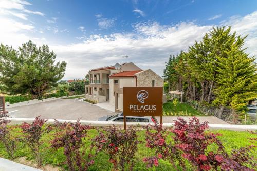 a sign in front of a building with a villa at Pelagus Luxury Villas in Polykhrono
